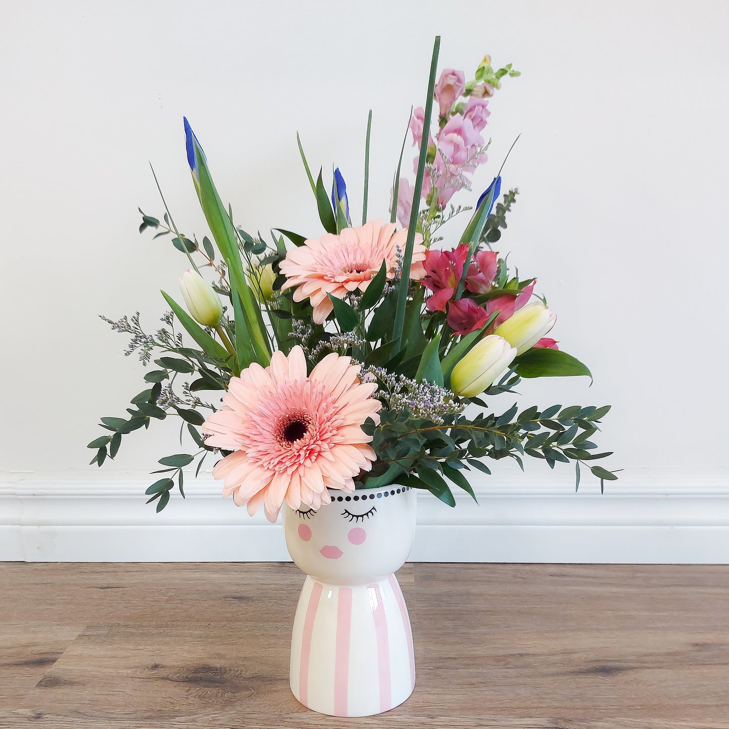 mixed flowers in lady vase