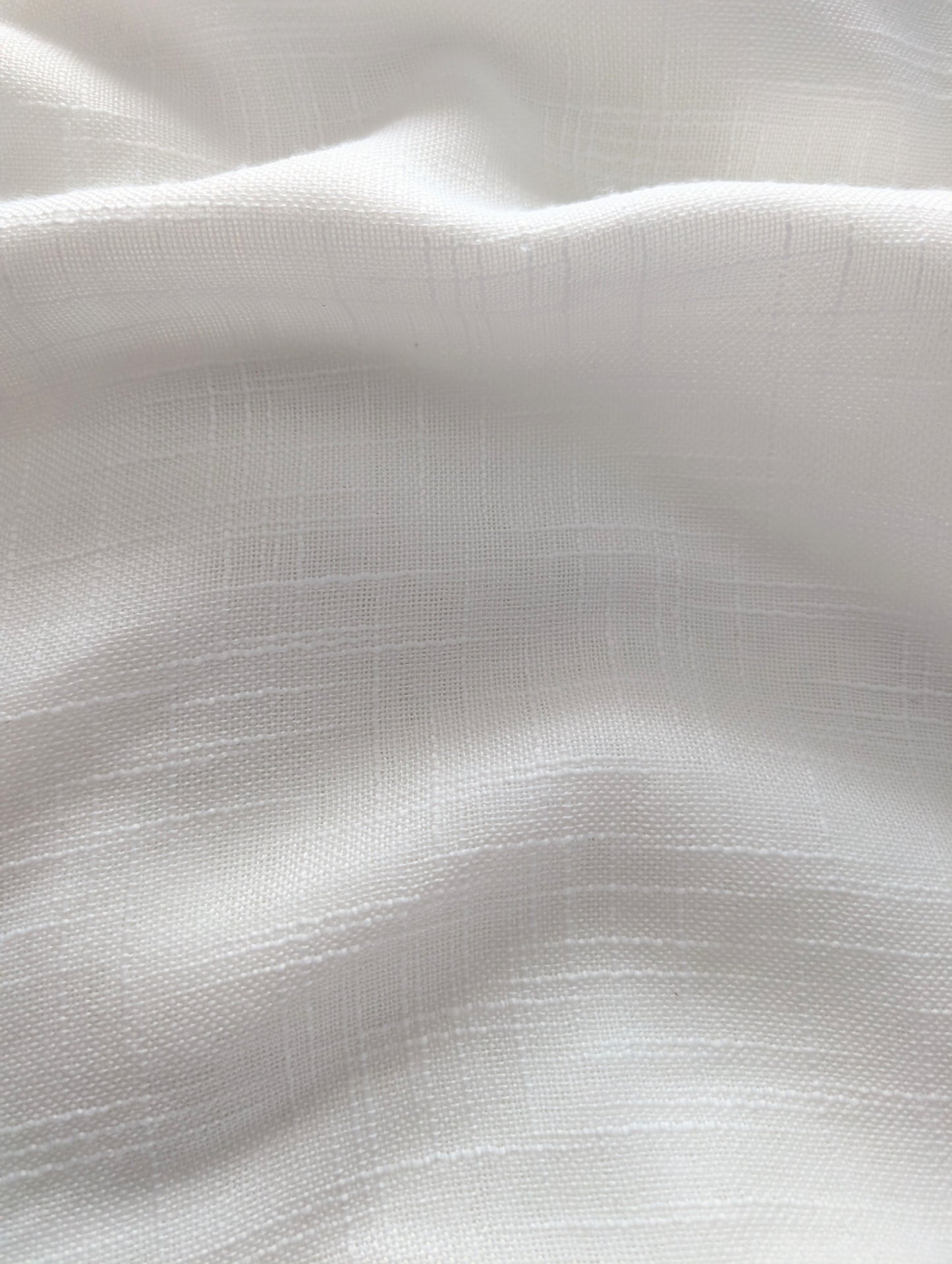 Close-up of white fabric with subtle texture