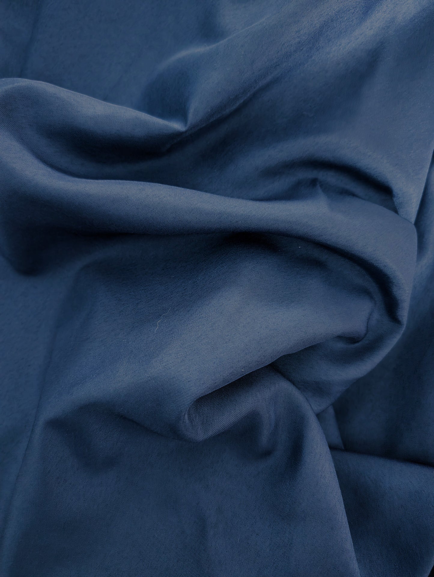 Close-up of blue fabric with folds