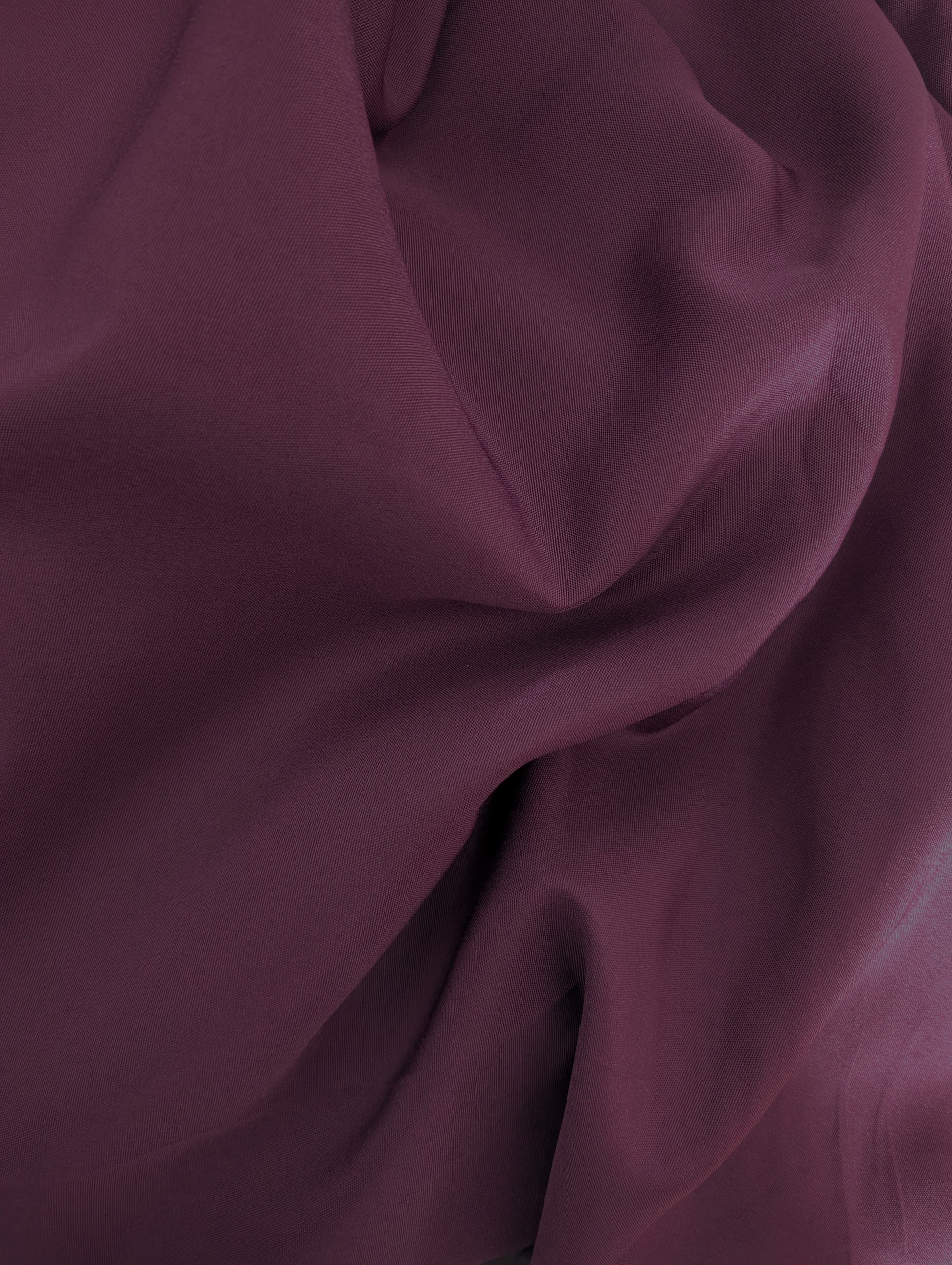Close-up of dark purple fabric with folds