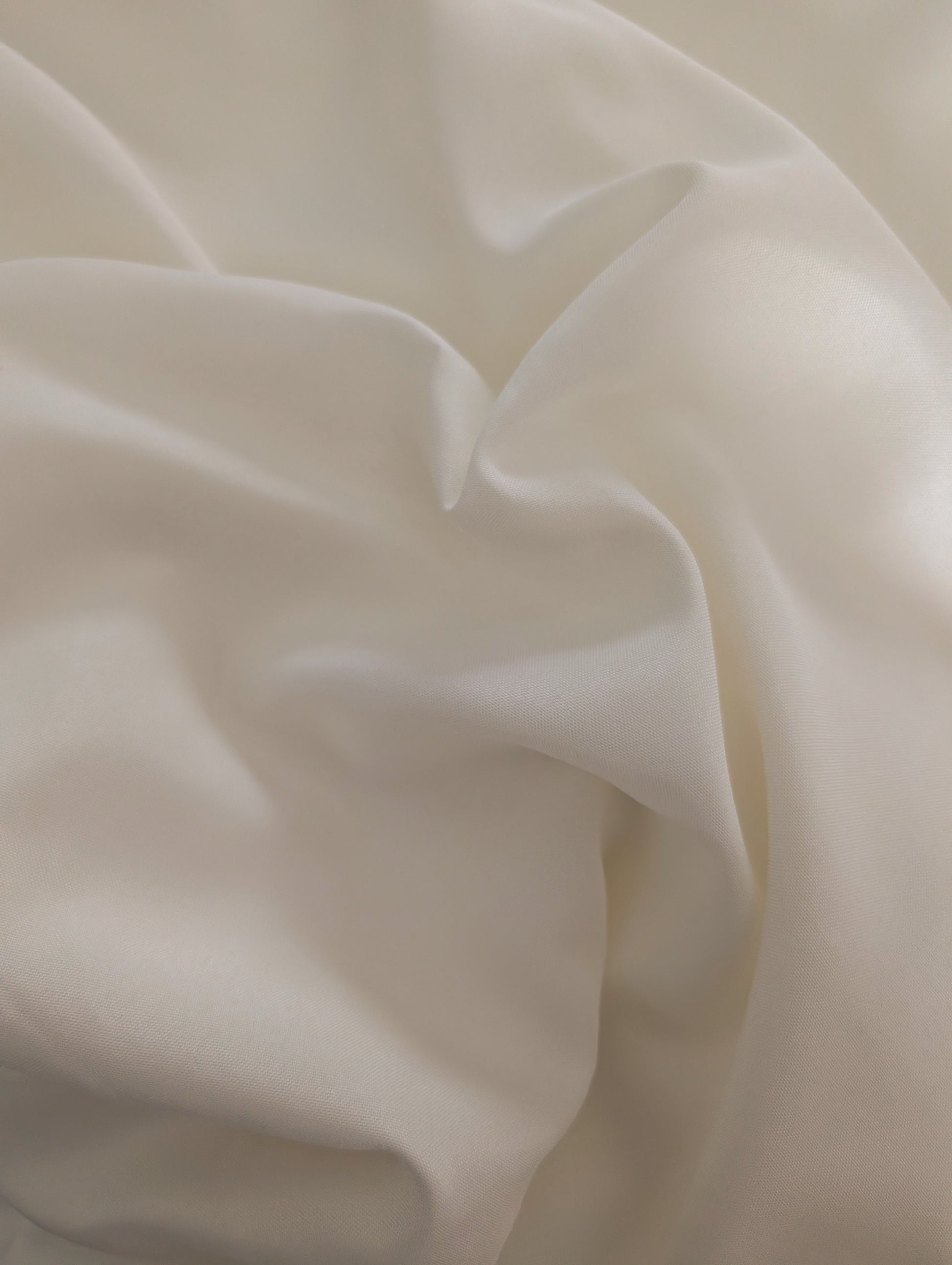 Close-up of beige fabric with folds
