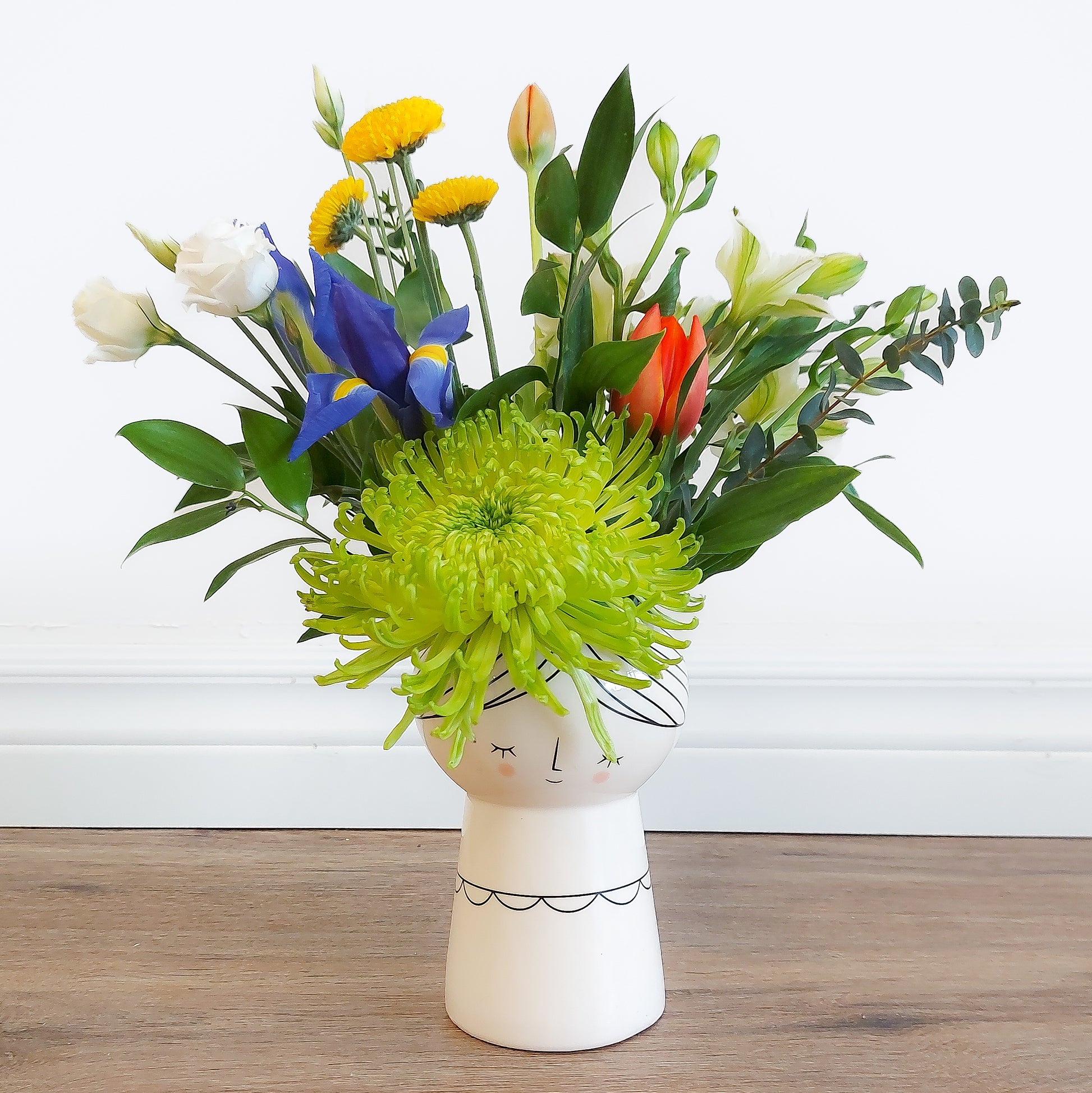mixed flowers in lady vase