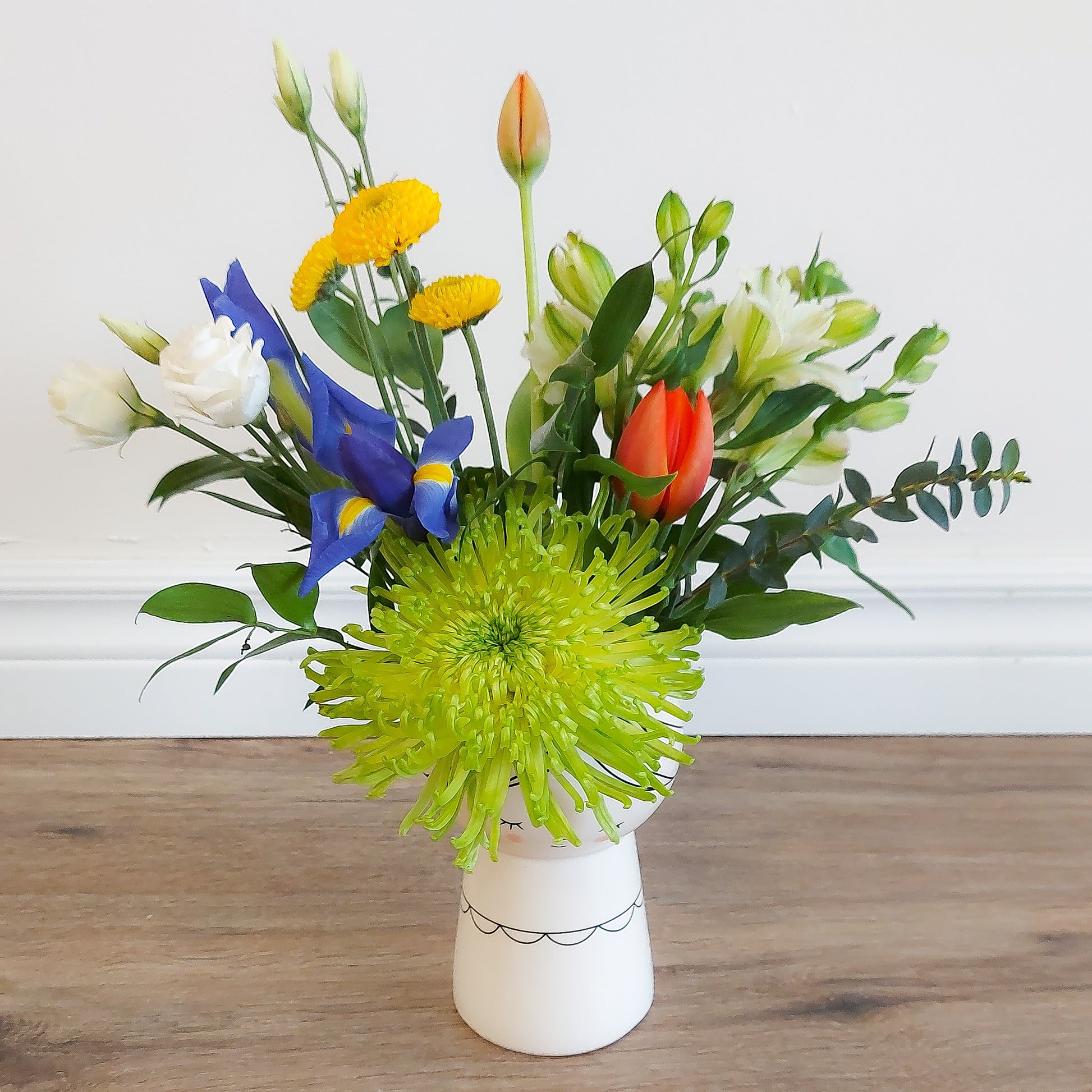 mixed flowers in lady vase