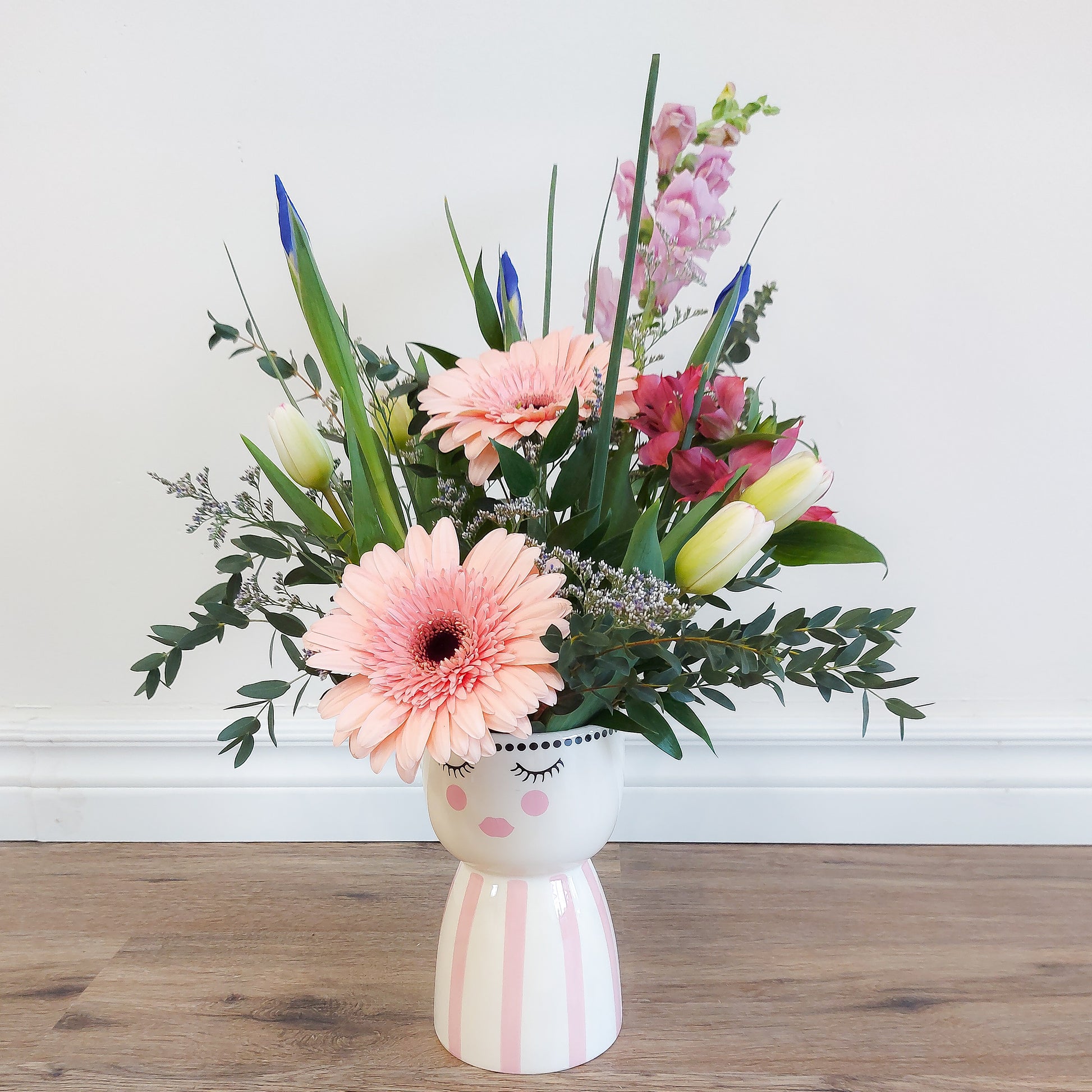mixed flowers in lady vase