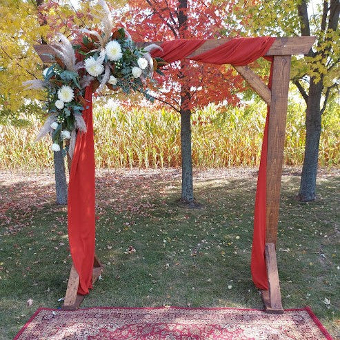 Fall wedding arch red drapes