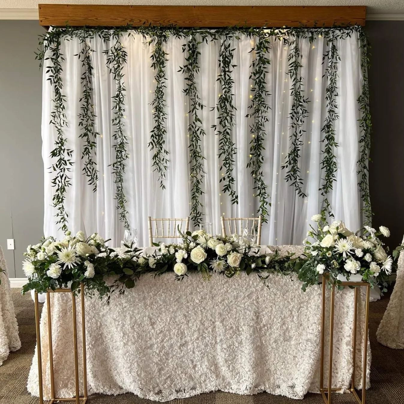 White drapes with trailing greenery